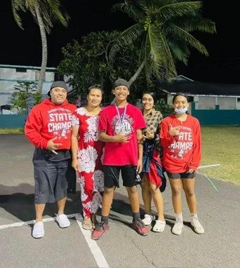 Jeri Galeaʻi with her family, all wearing red.