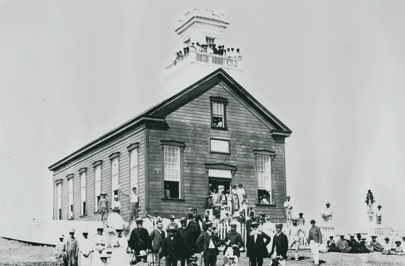 People of Lā'ie crowd around their newly completed wooden chapel.