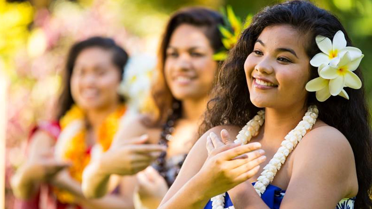 Three women performing a graceful hula.