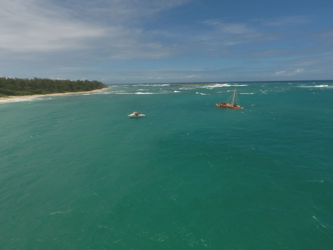 The Iosepa being escorted into port by a small boat.