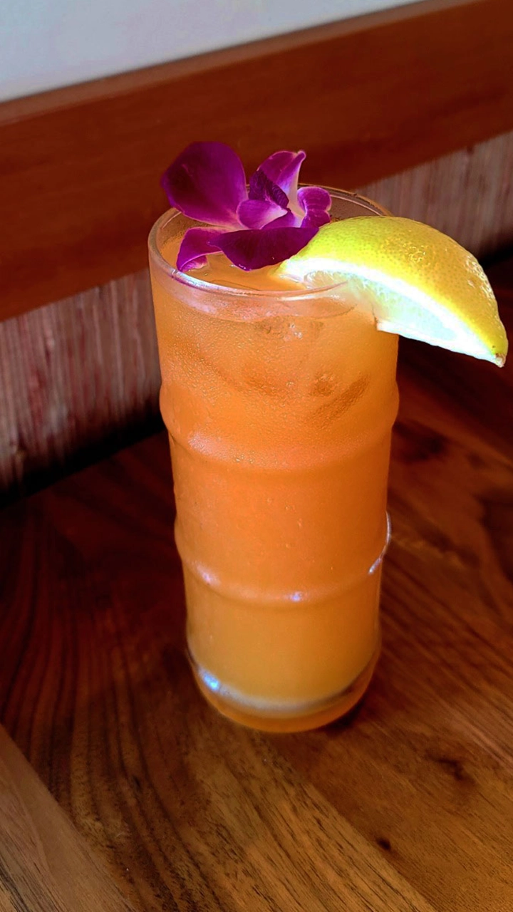 A glass of Pineapple Orange and Guava juice.