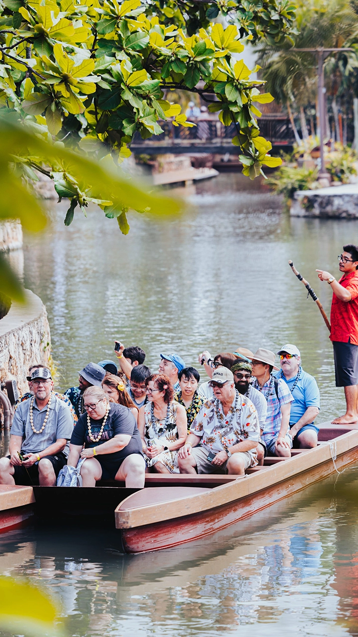 Canoe trip with guests and canoe pusher at Polynesian Cultural Center.