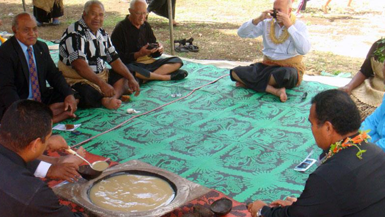 Men sitting in a circle and drinking kava.