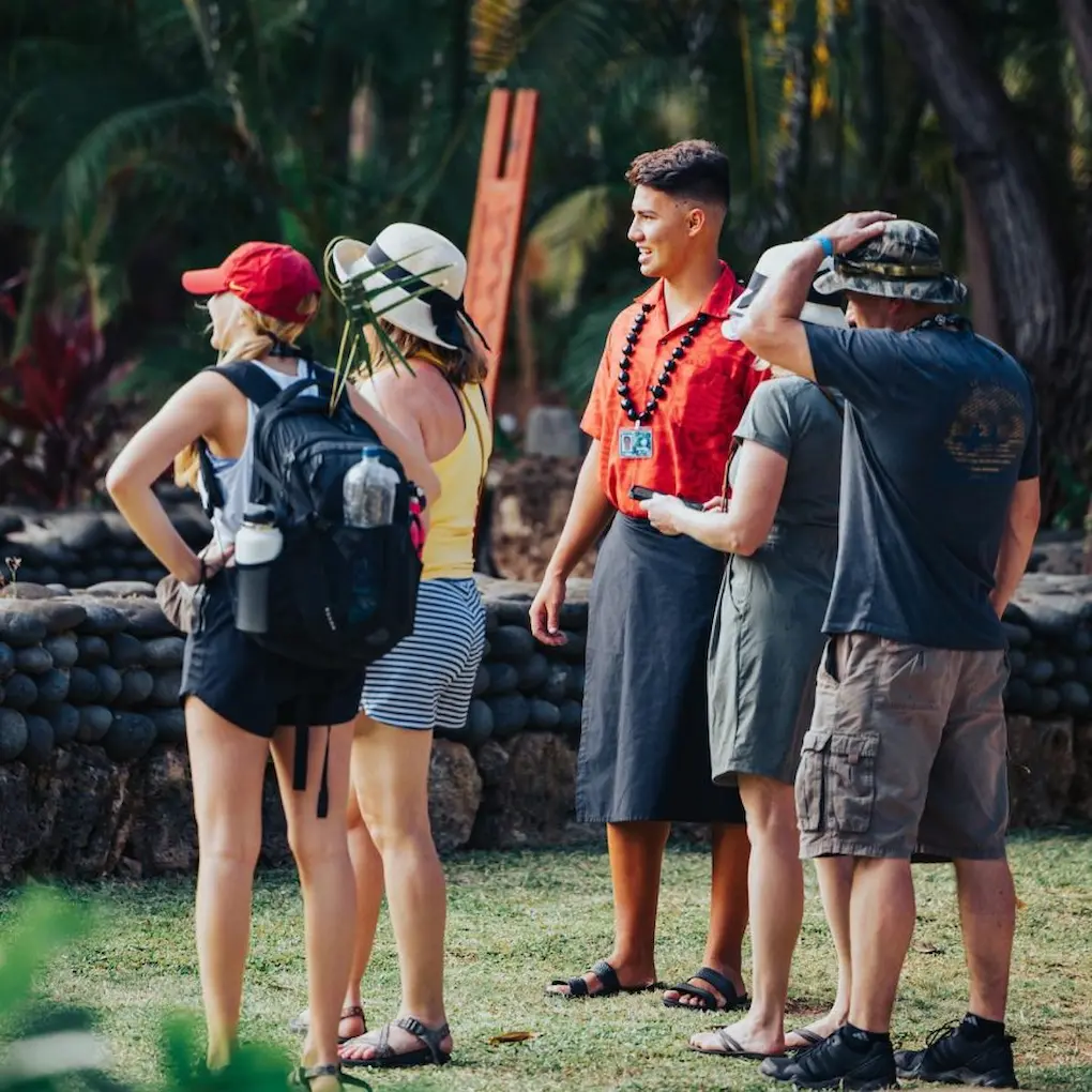 Polynesian tour guide providing a guided tour to four guests.