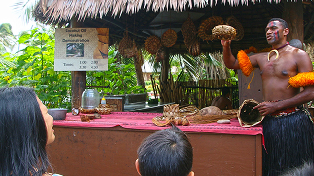 A Fijian guide at the Polynesian Cultural Center demonstrates some of the useful items made from the coconut tree or &ldquo;tree of life,&rdquo; as it is often called in Polynesia.