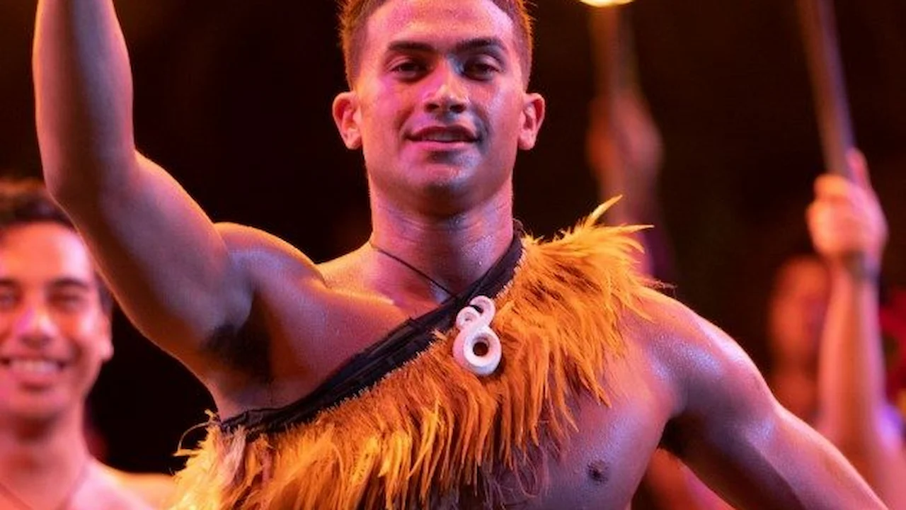 Performer wearing a large, white pedant.