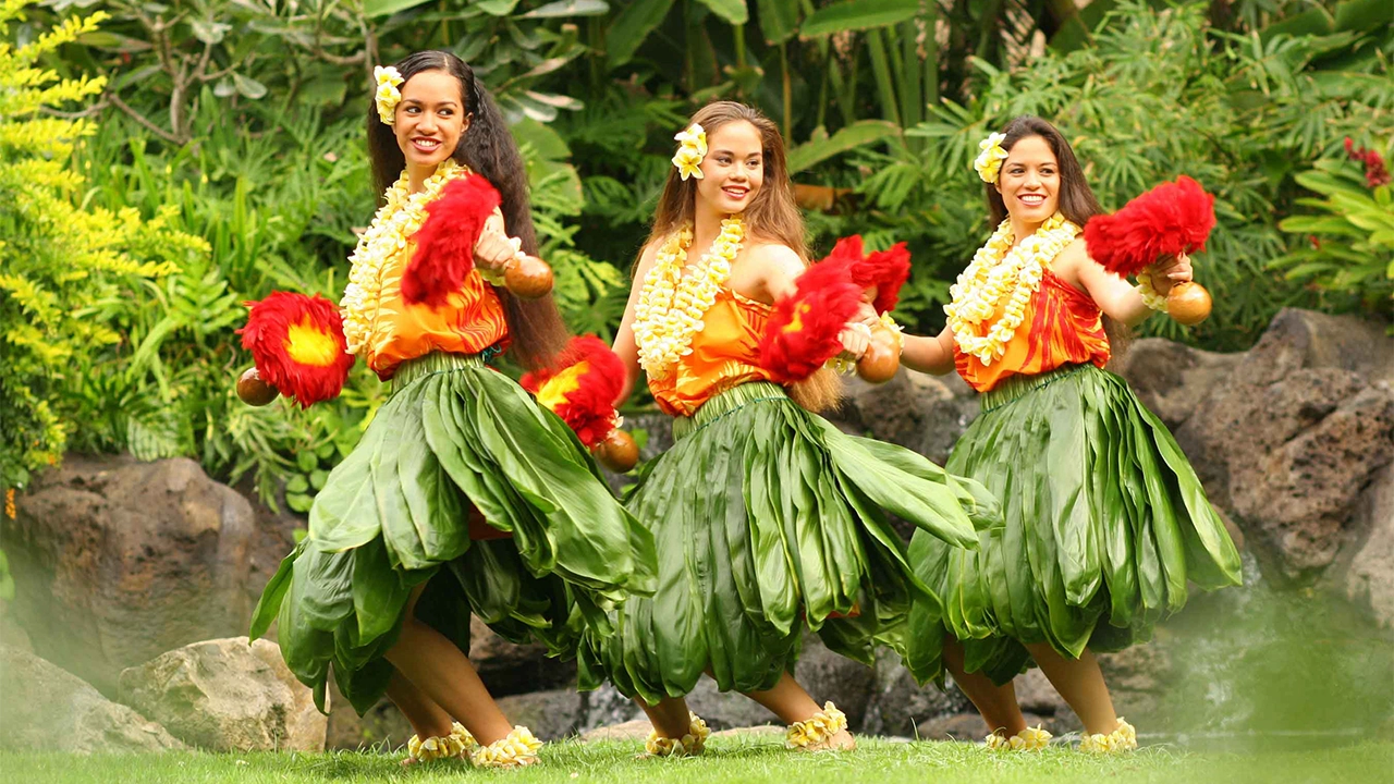 Three Hawaiian girls dancing hula