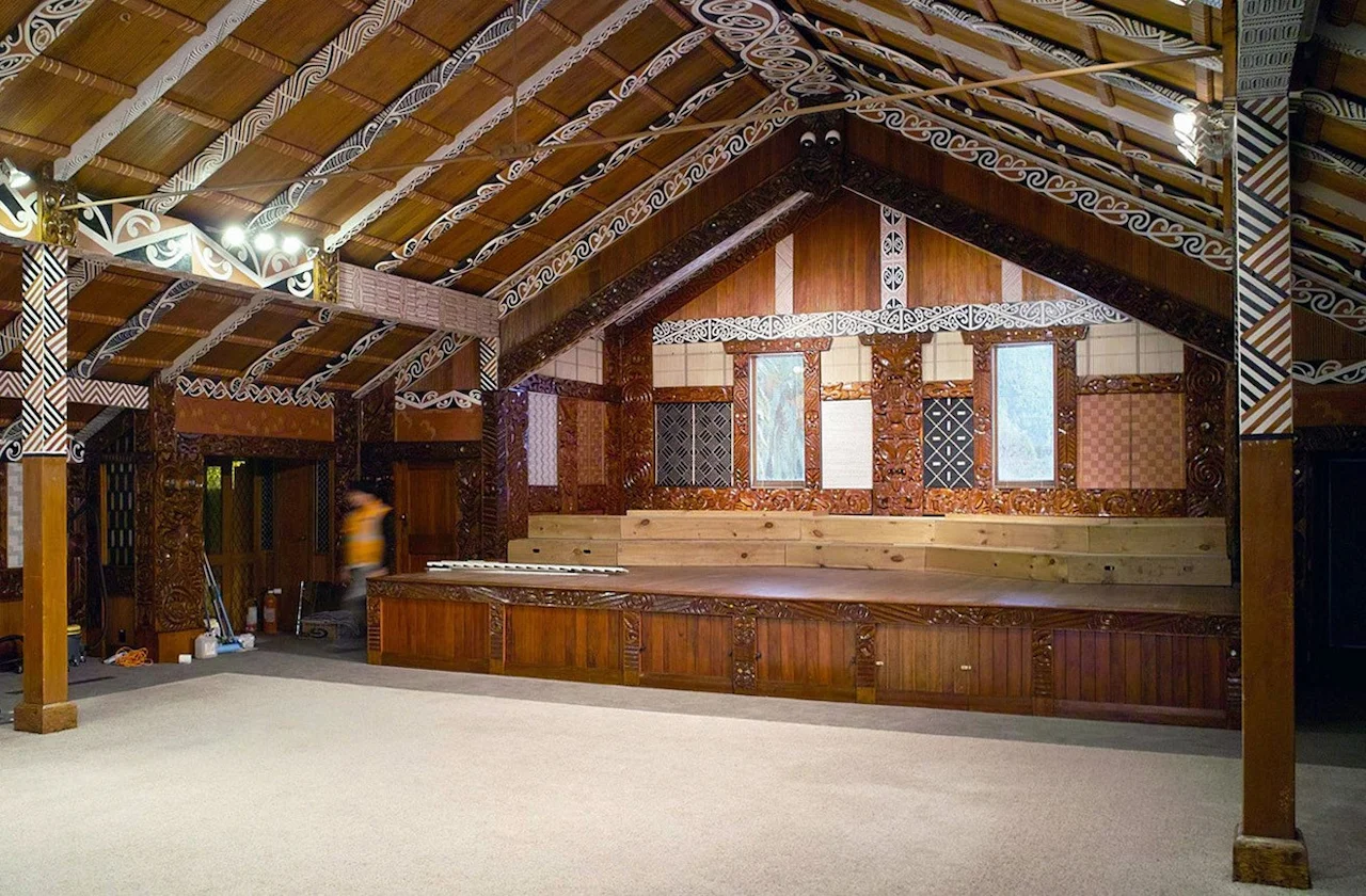 Interior view of the Tūrangawaewae Marae, a large wood building with various Māori patterns in the architecture.