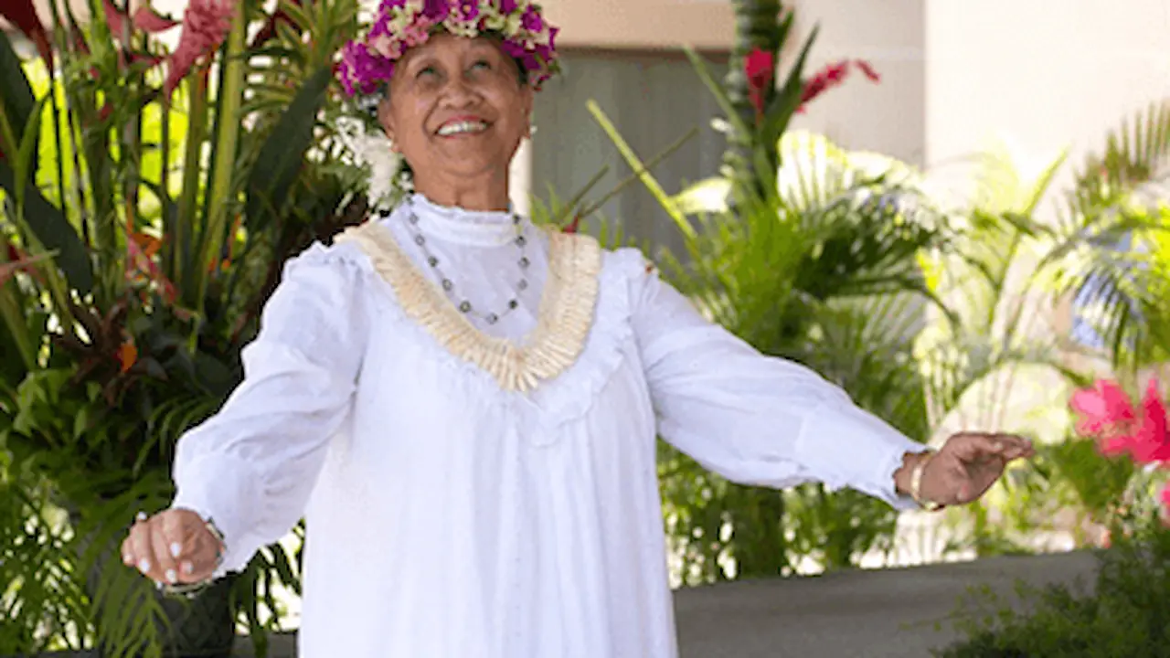 Kekela (Kela) Miller smiling and wearing a white gown.