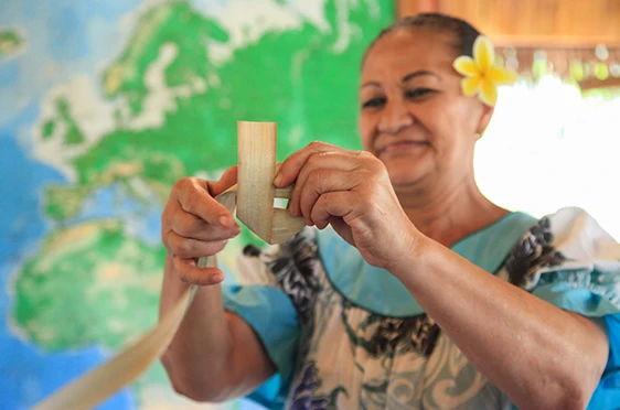Lady weaving lauhala bark