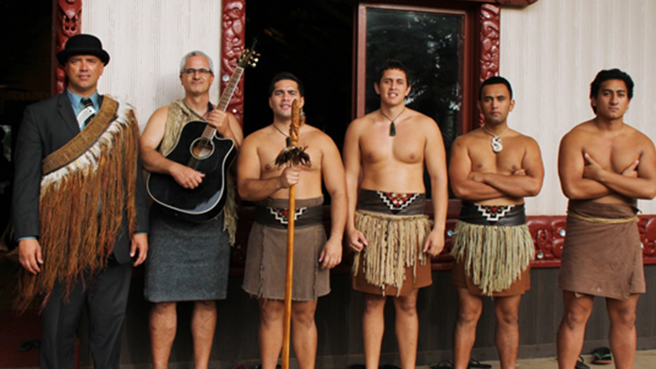Seamus Fitzgerald with the male performers of the Māori village.