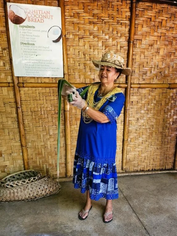 Regina Pasi, former employee at the Polynesian Cultural Center, demonstrating how to wrap coconut bread.